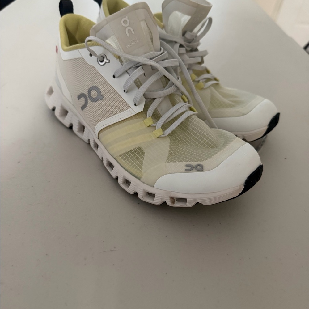 On Running White and Yellow Athletic Shoes